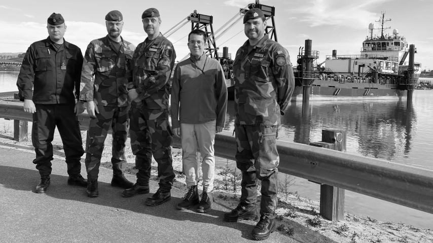 Johannes with four uniformed military officers on a quayside, a ship moored behind them
