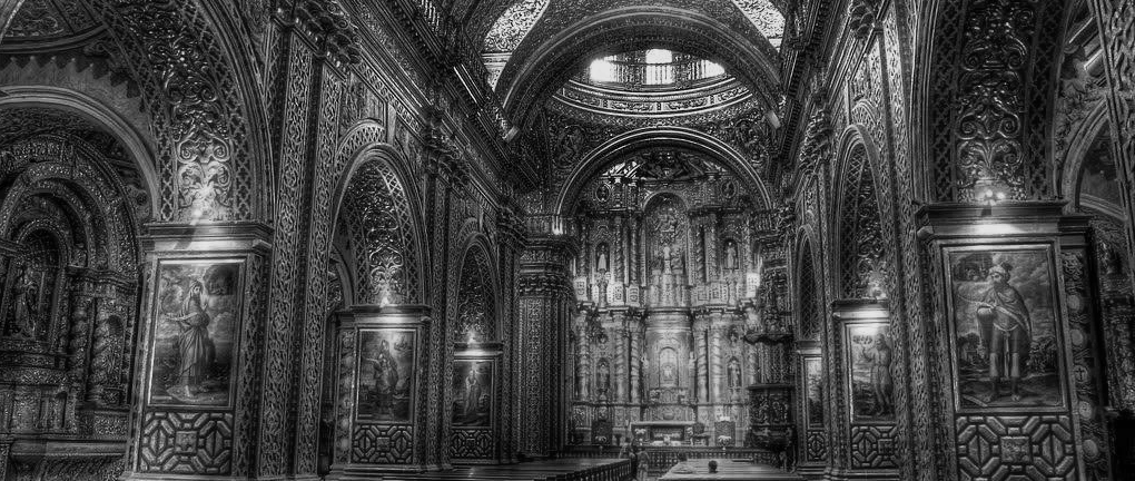 The carved and gilded nave and altarpiece of a Baroque Jesuit church